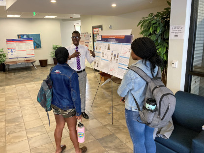 Graduate student presenting his research poster.