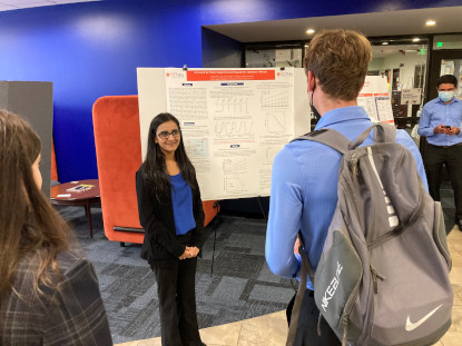 Student presenting her research poster