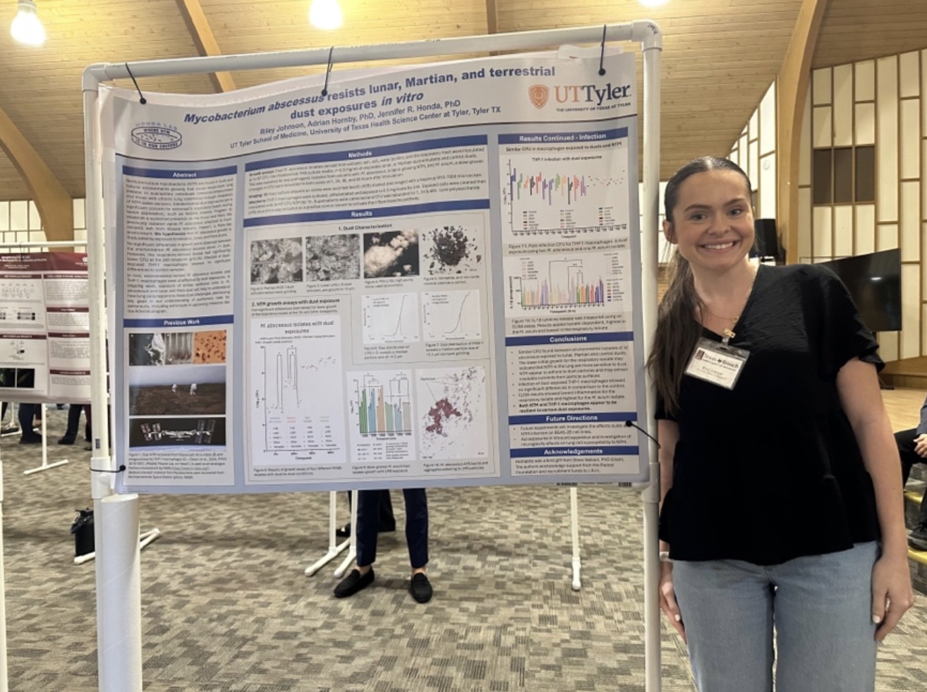 Riley Johnson posing next to her presentation