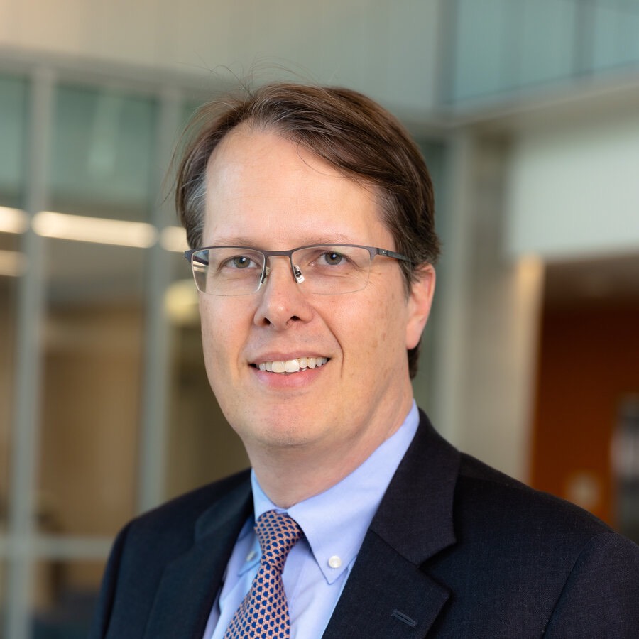 man in a tie and suit smiling