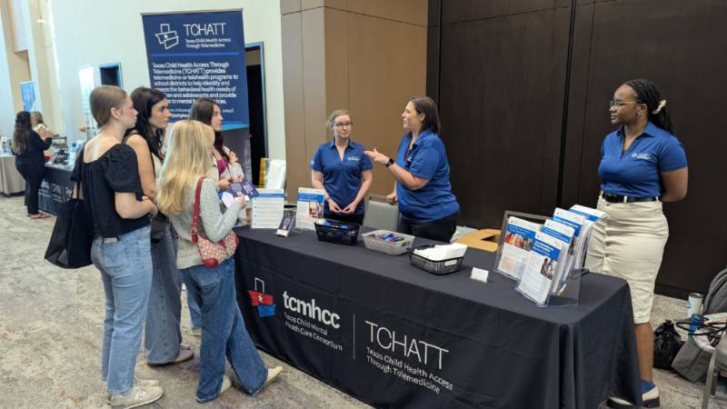 Staff standing at table during event
