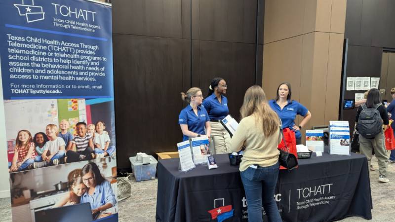 Staff standing at table during event