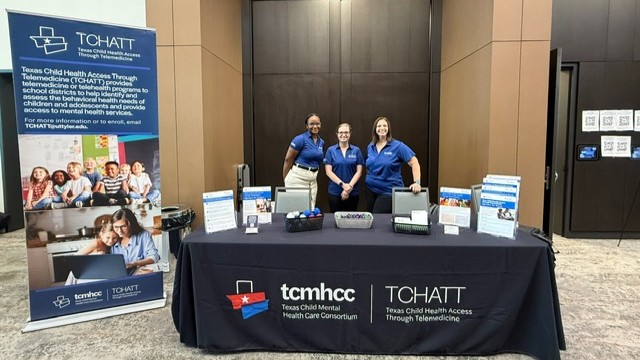 Staff standing at table during event