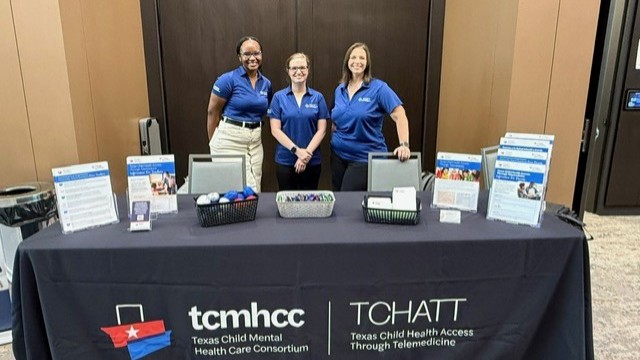 Staff standing at table during event