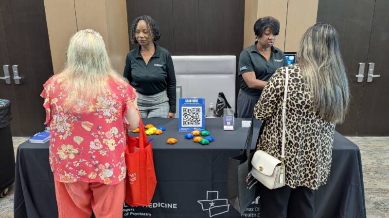 Staff standing at table during event