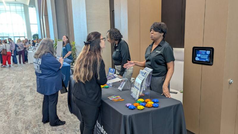 Staff standing at table during event