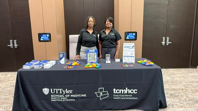 Staff standing at table during event