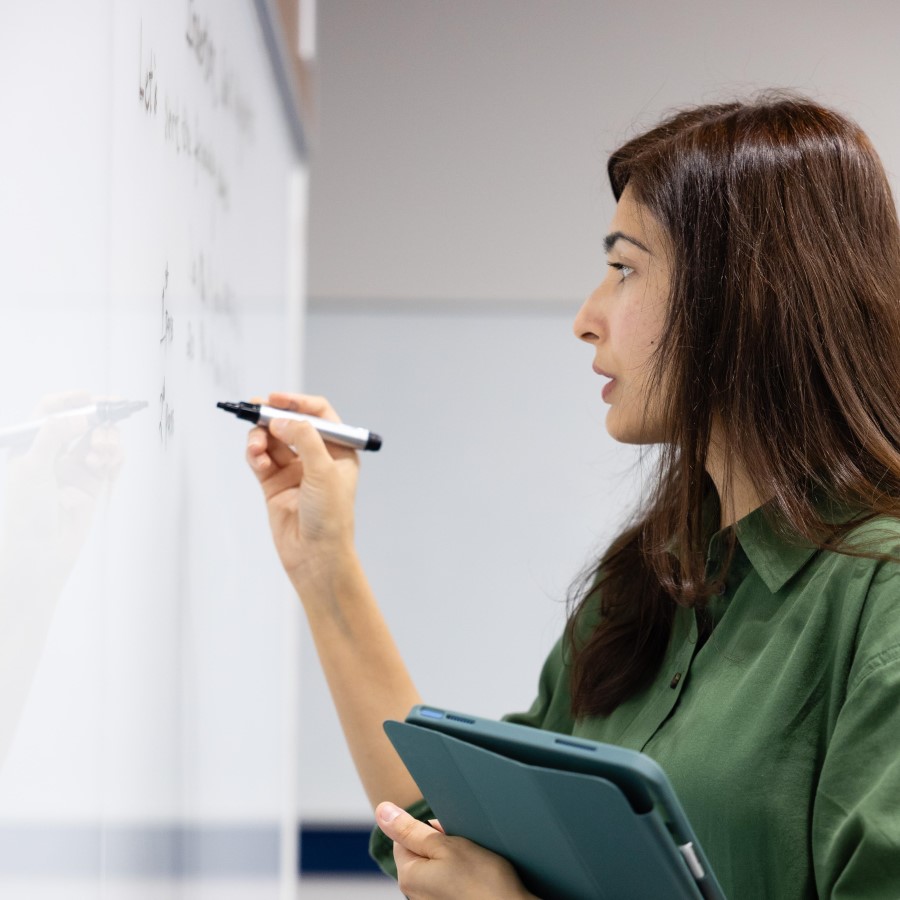teacher writing on the whiteboard