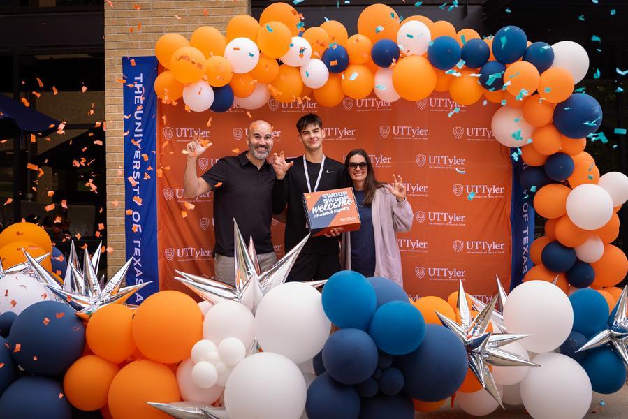 student and parents celebrating