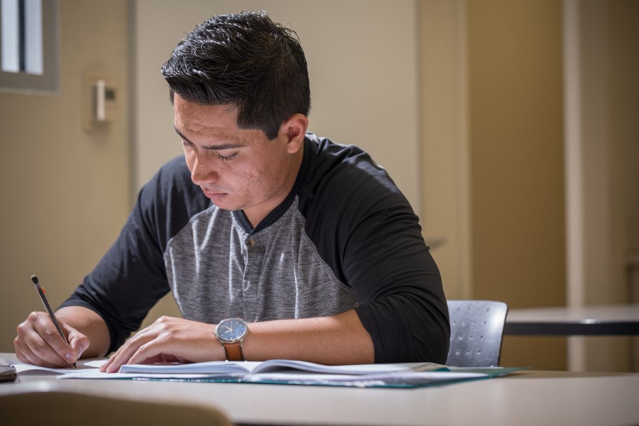 Person at a desk writing on a document