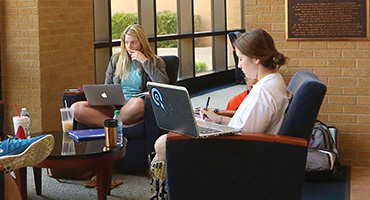 UT Tyler Students studying in chairs