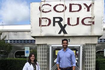 Bell and Douglas in front of Cody Drug Pharmacy