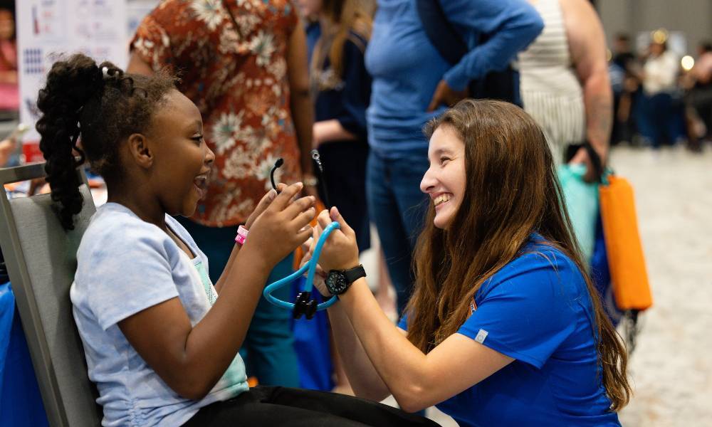 Nursing student teaching kid