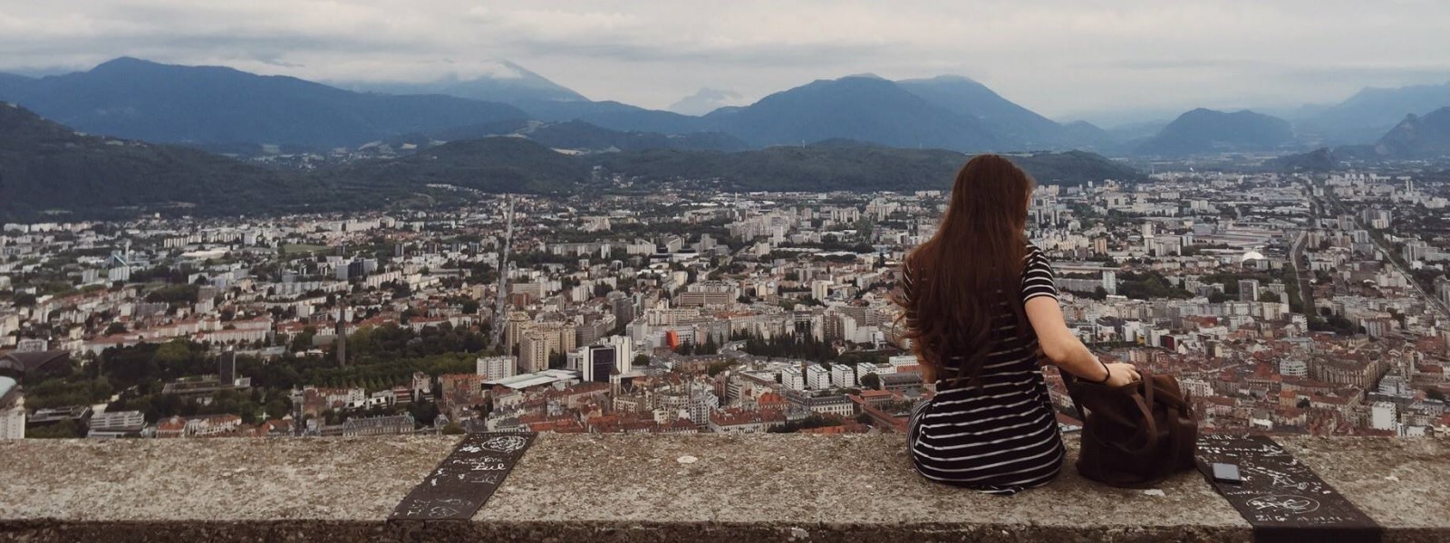 student overlooking Grenoble